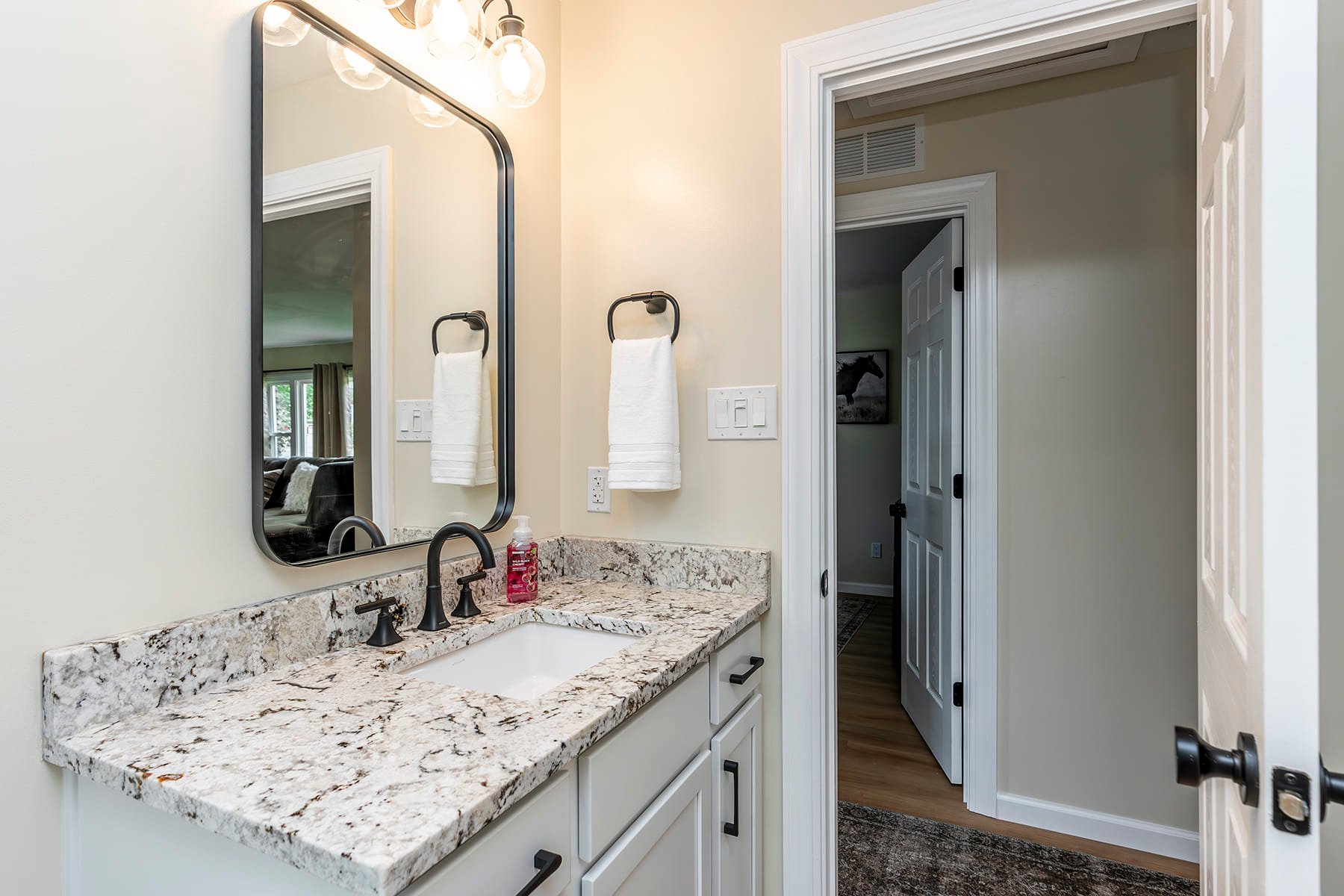 Elegant Vanity and Mirror in bathroom remodel